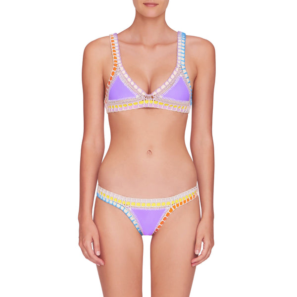 front image of lavender color kiini bikini top and bottom with multi color crochet elastic trim on model