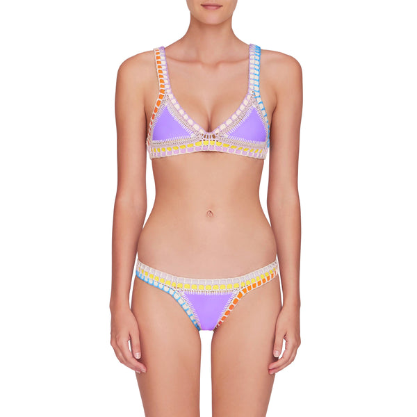 front image of lavender color kiini bikini top and bottom with multi color crochet elastic trim on model